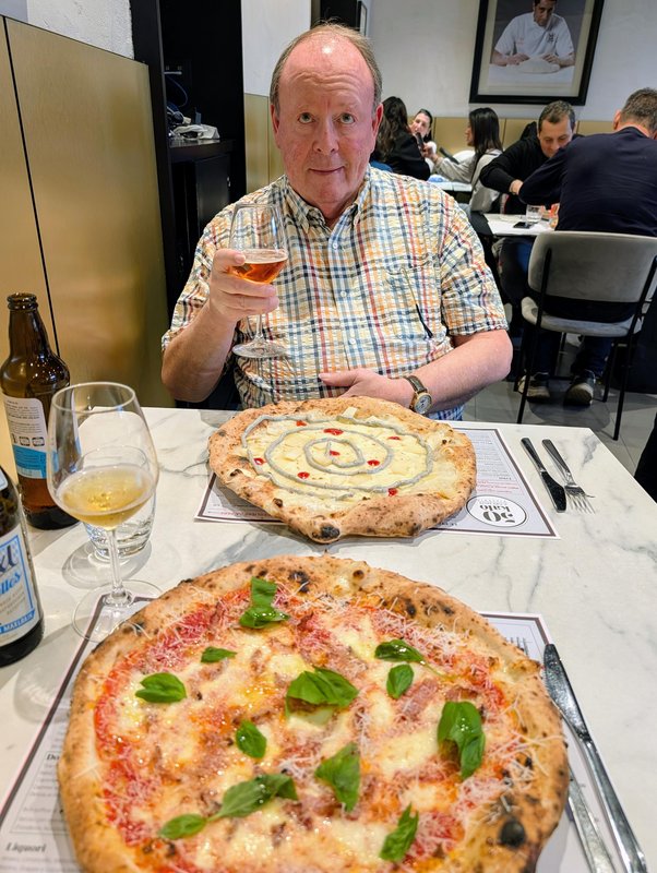 Ken with a beer and two pizzas in front of him. 4 cheeses for him, a tomato / guancale / pecorino for me.