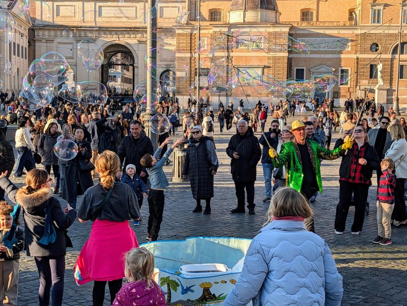 Bubbles being blown and a boy reaching for them