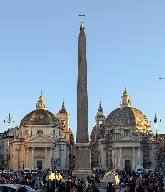 Obelisk framed between two domes