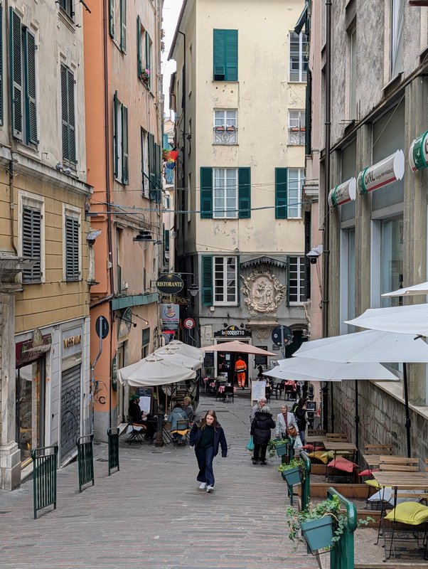 A typical city center street, with tiny caruggi branching off of it
