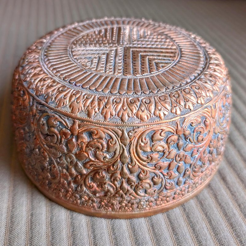 A copper bowl with hammered design