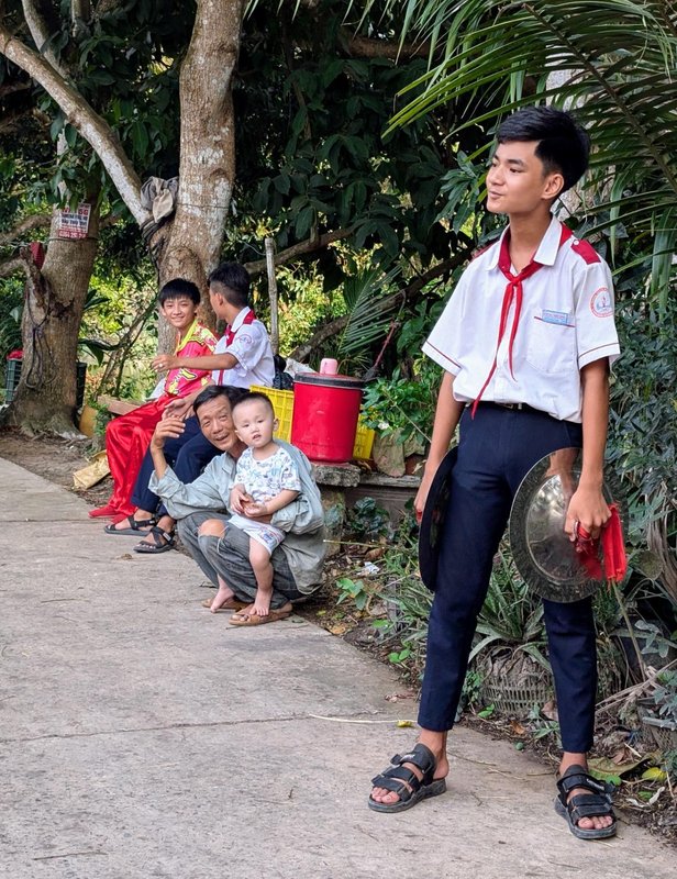 The cymbal player, plus some village spectators